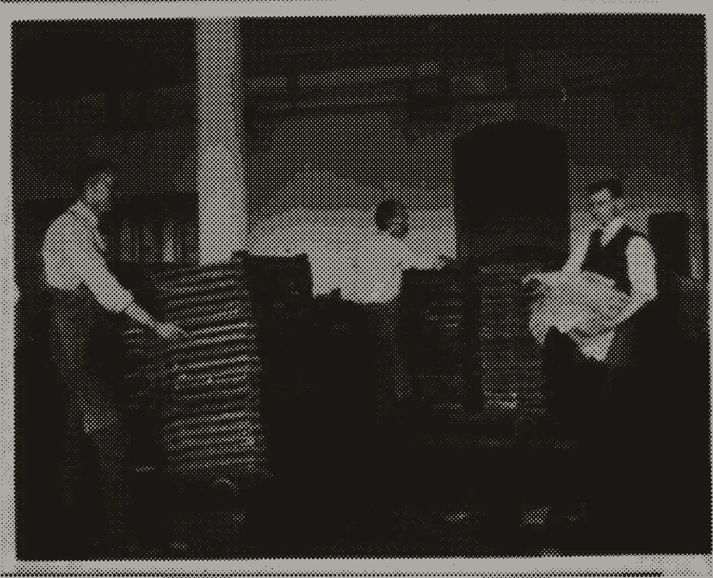 Halftone photograph of workers stacking sheets of newly printed currency